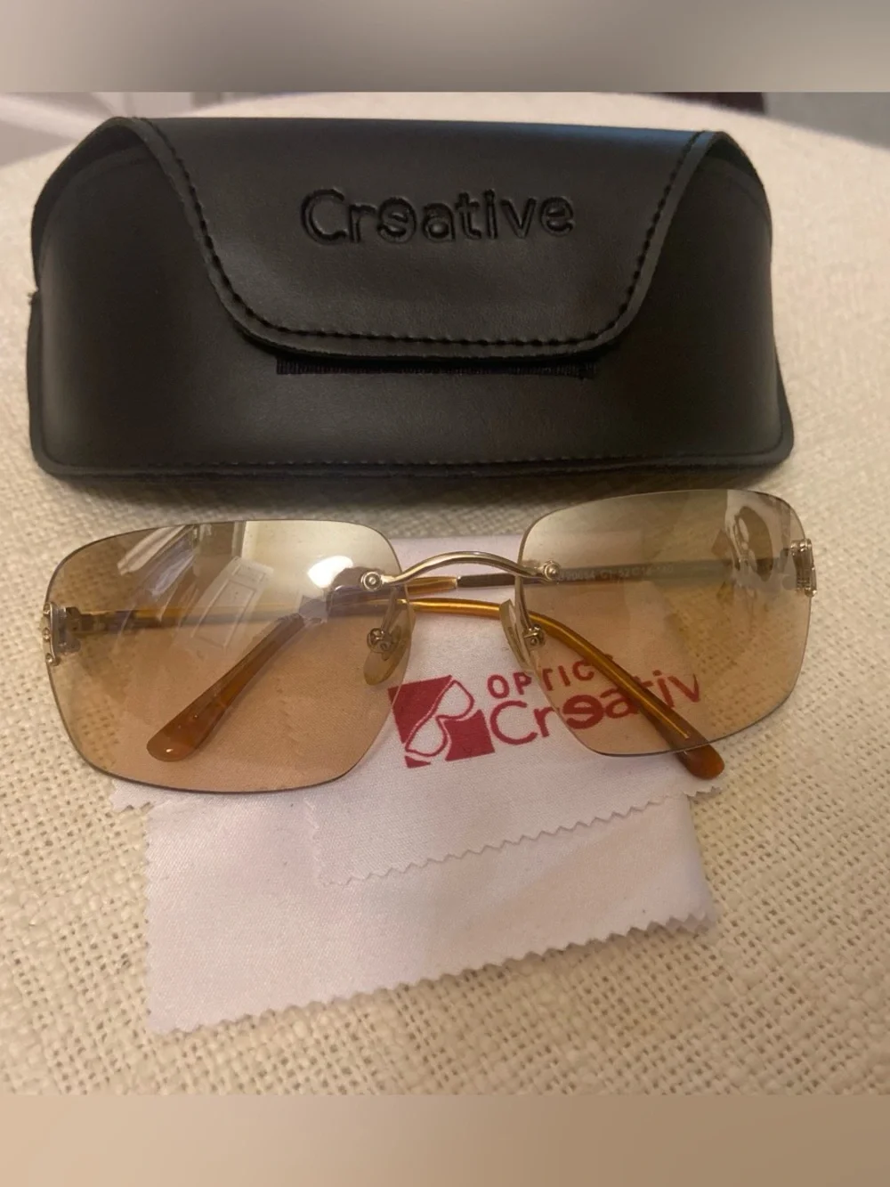 2000s style creative optics sunglasses with brown lenses and gold frames